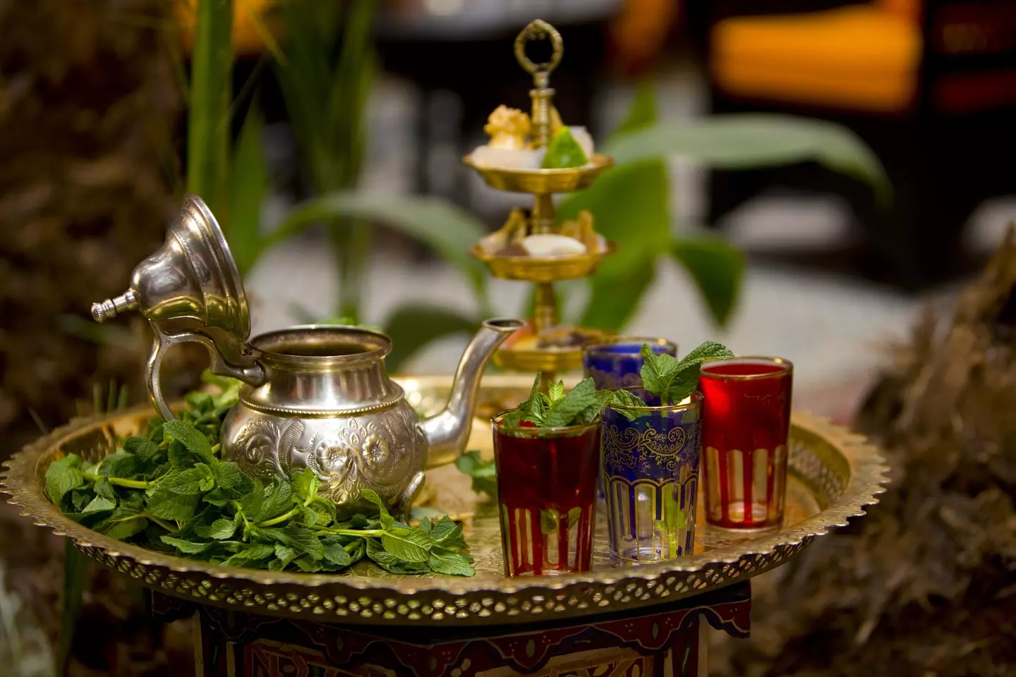 What is special about Moroccan mint tea. A traditional Moroccan mint tea served in small glasses with fresh mint leaves, a silver teapot, and sugar cubes.