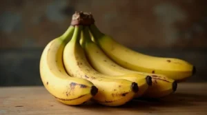 The #1 Mistake People Make When Baking Banana Bread (and How to Avoid It) 2 A bunch of overripe bananas with brown spots on their peel, resting on a wooden kitchen countertop."