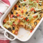 Delicious best taco casserole topped with cheese and tortilla chips